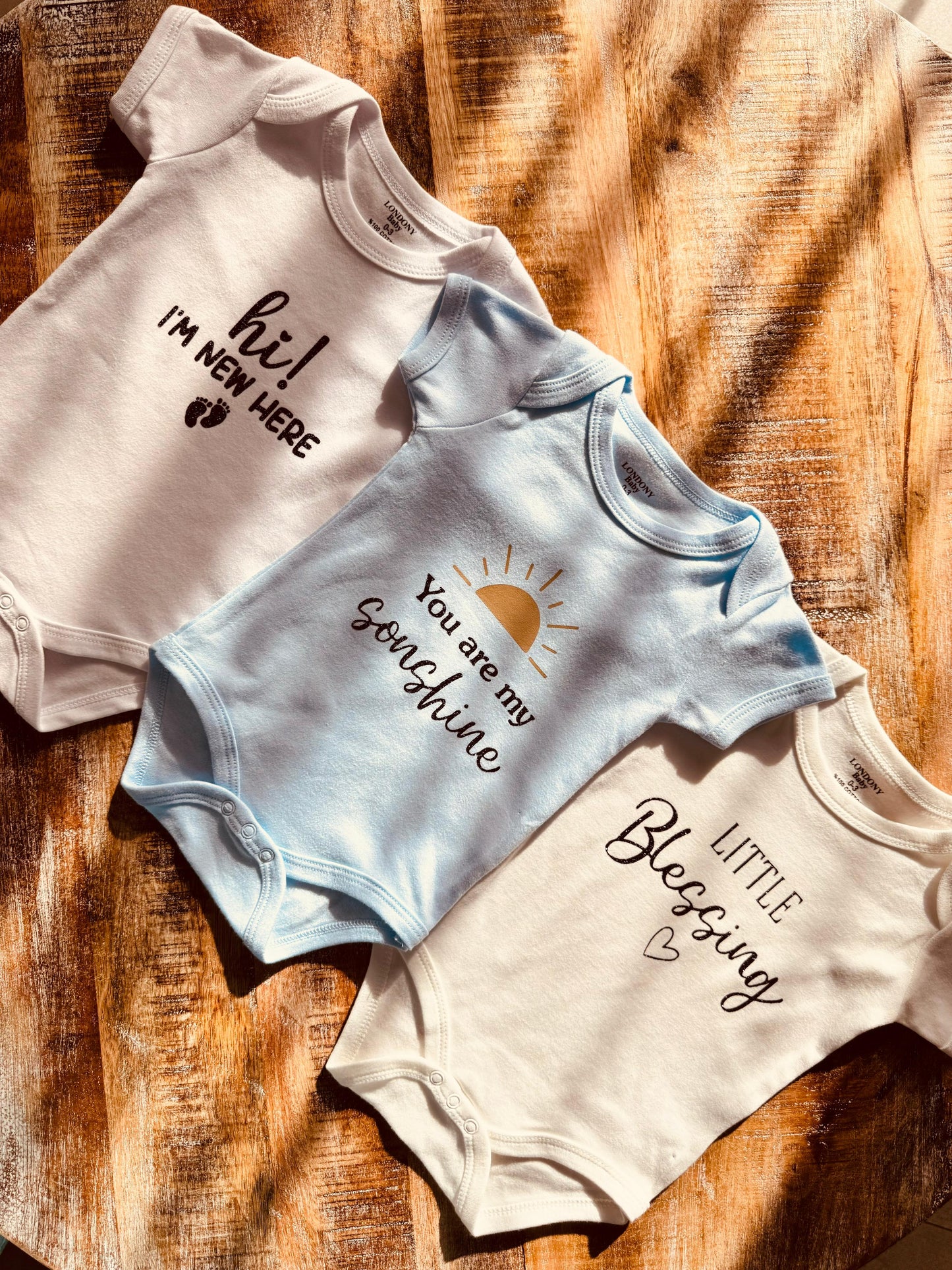 Personalized baby onesie set with custom name, perfect for newborn gifts and baby showers, baby annoucement | in the UAE.