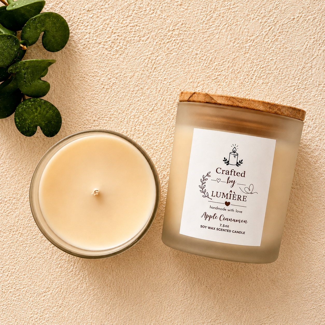 A frosted glass candle jar with a bamboo wood lid sits next to an open candle showing the cream-colored wax. The label reads 'Crafted by Lumière' and 'Apple Cinnamon'.